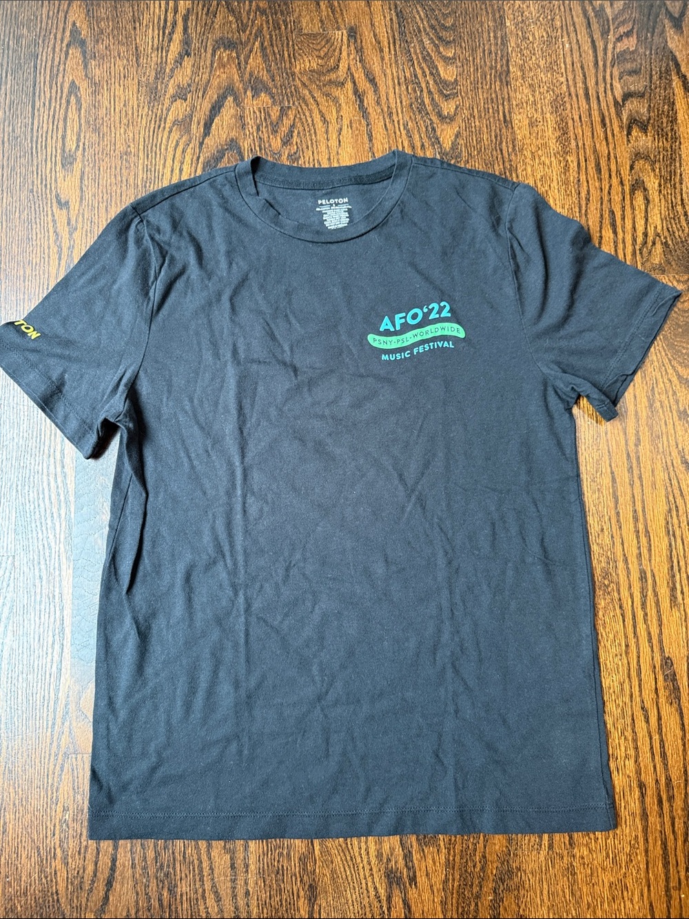 Peloton Black Short Sleeve Tee with Teal Festival Logo